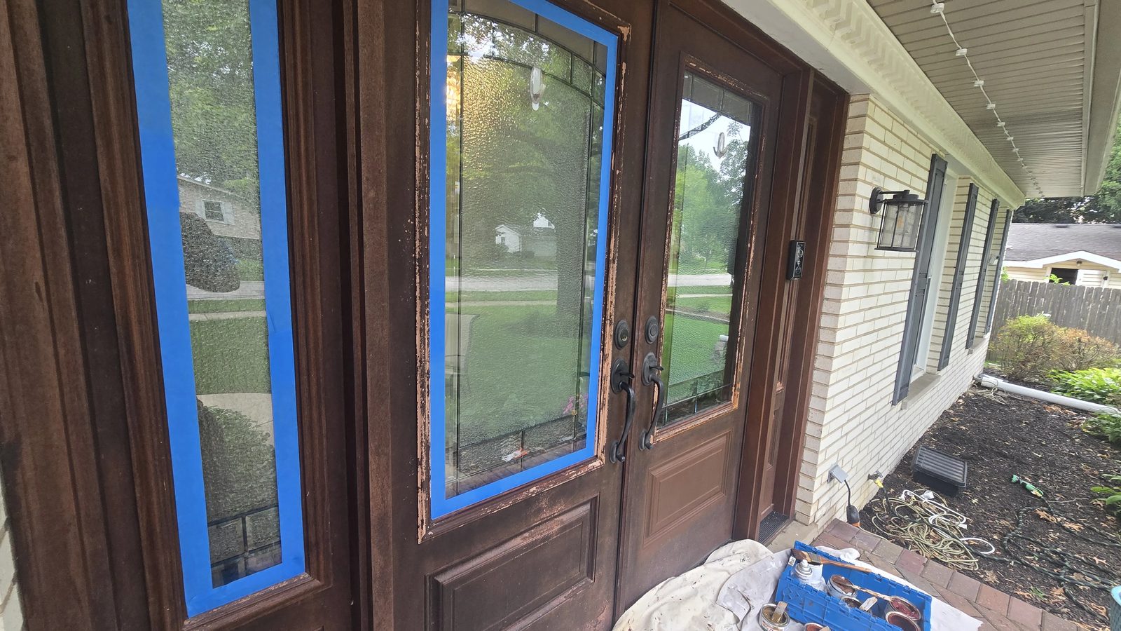 Fiberglass entry door system before refinishing, peeling finish